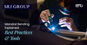 A close-up of a welder in a protective helmet and gloves performing a precise welding operation on a metal pipe, with bright blue light from the welding arc. The text "SRJ GROUP Mandrel Bending Explained: Best Practices & Tools" is overlaid.