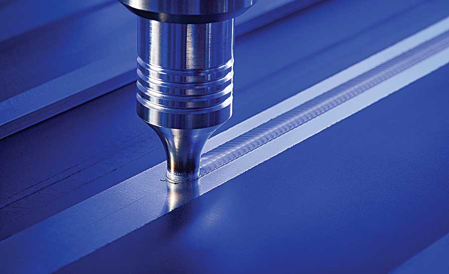 Close-up of a friction stir welding tool creating a seamless joint on a metal surface.