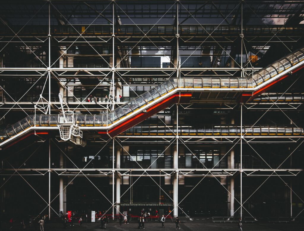 External industrial framework showing complex exposed structural supports and diagonal bracing design.
